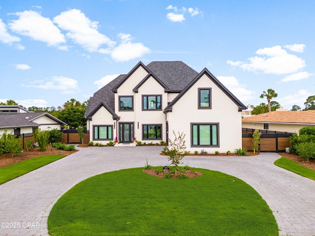 1507 Trout Ln, Panama City Beach, FL 32408 - view of front of property featuring stucco siding, curved driveway, and a shingled roof