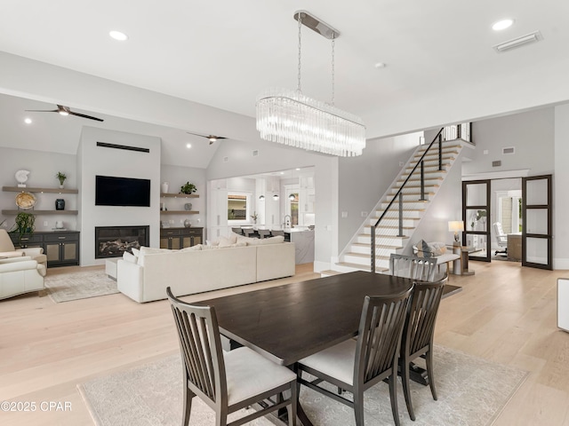 1507 Trout Ln, Panama City Beach, FL 32408 - dining room featuring vaulted ceiling, healthy amount of natural light, stairway, light wood-type flooring, and recessed lighting