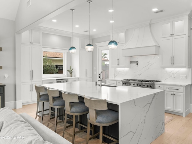 1507 Trout Ln, Panama City Beach, FL 32408 - kitchen with a sink, wall chimney range hood, healthy amount of natural light, tasteful backsplash, and crown molding