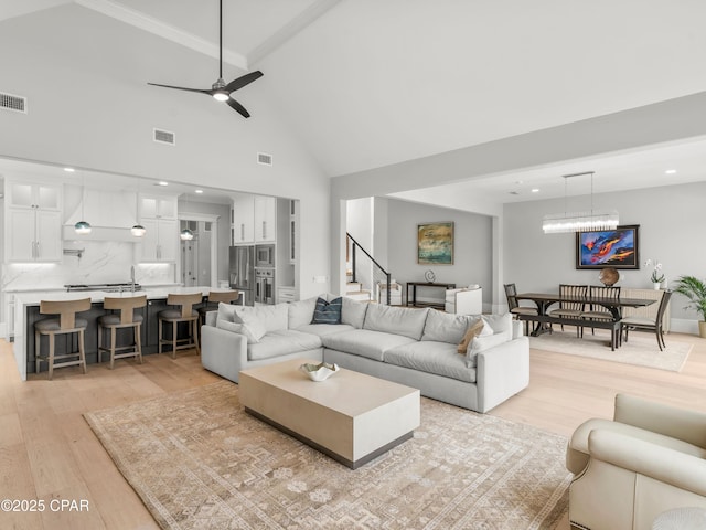 1507 Trout Ln, Panama City Beach, FL 32408 - living area with light wood-style flooring, stairway, high vaulted ceiling, ceiling fan, and recessed lighting