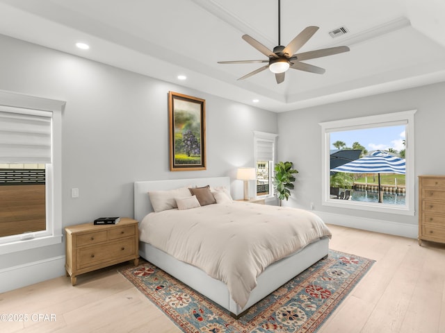 1507 Trout Ln, Panama City Beach, FL 32408 - bedroom featuring light wood-type flooring, recessed lighting, a raised ceiling, and a ceiling fan