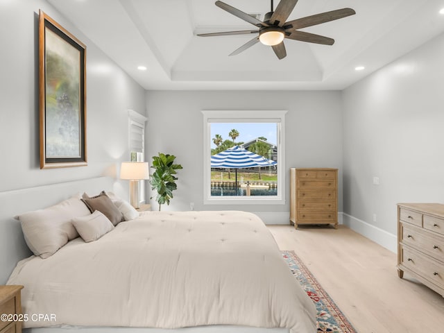 1507 Trout Ln, Panama City Beach, FL 32408 - bedroom with a tray ceiling, light wood finished floors, recessed lighting, baseboards, and a ceiling fan