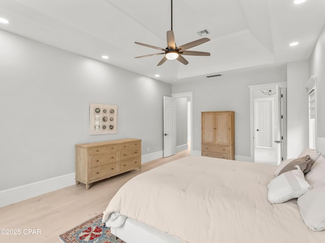 1507 Trout Ln, Panama City Beach, FL 32408 - bedroom with recessed lighting, light wood-style floors, baseboards, a tray ceiling, and ceiling fan