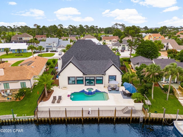 1507 Trout Ln, Panama City Beach, FL 32408 - rear view of house with a residential view, stucco siding, a patio, and a pool with connected hot tub