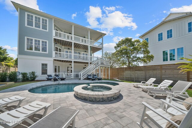 58 Hightide Way, Inlet Beach, FL 32413 - rear view of house with a fenced backyard, an in-ground hot tub, stairs, and a patio