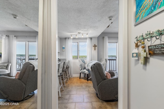 23223 Front Beach Rd Unit A704, Panama City Beach, FL 32413 - living area with a textured ceiling, tile patterned flooring, and baseboards