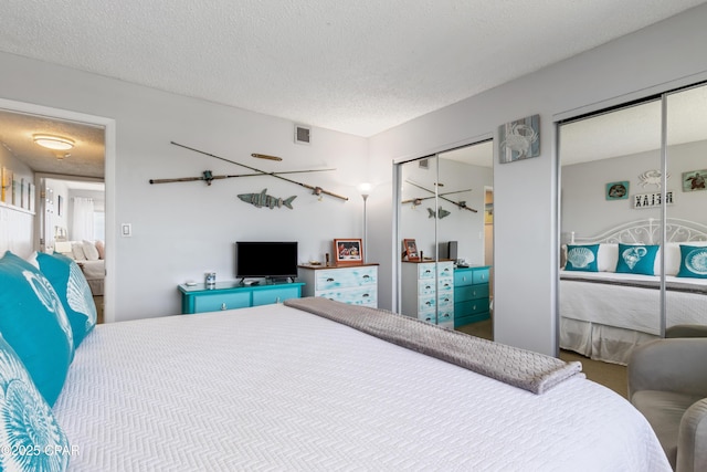 23223 Front Beach Rd Unit A704, Panama City Beach, FL 32413 - bedroom with multiple closets and a textured ceiling