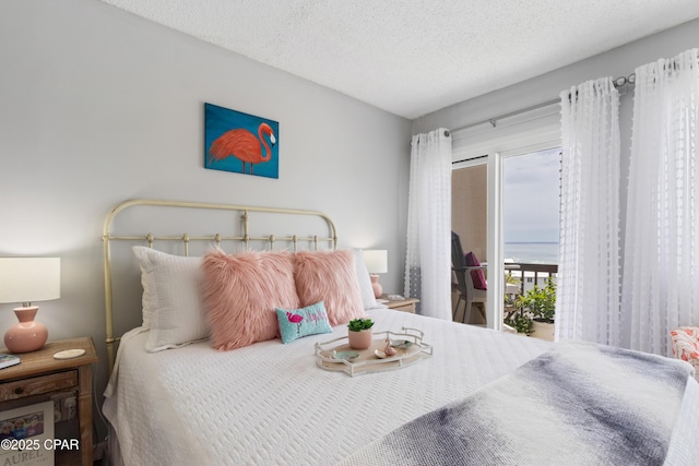 23223 Front Beach Rd Unit A704, Panama City Beach, FL 32413 - bedroom featuring access to exterior and a textured ceiling