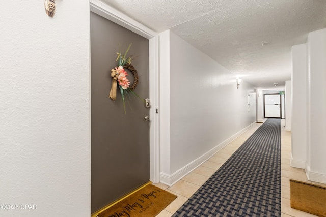 23223 Front Beach Rd Unit A704, Panama City Beach, FL 32413 - hall with a textured ceiling, light tile patterned floors, and baseboards