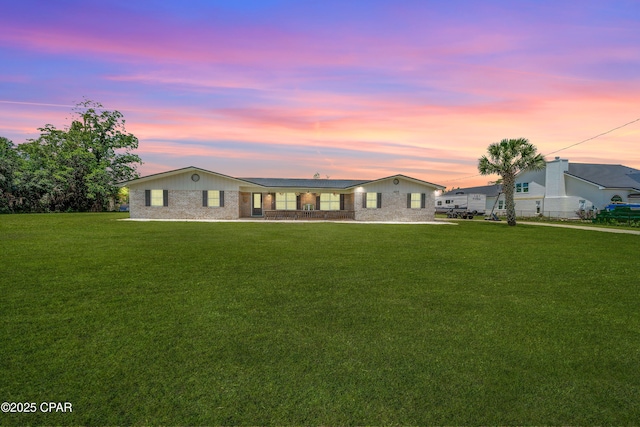 1026 Harvard Blvd, Lynn Haven, FL 32444 - back of property at dusk with a yard and brick siding