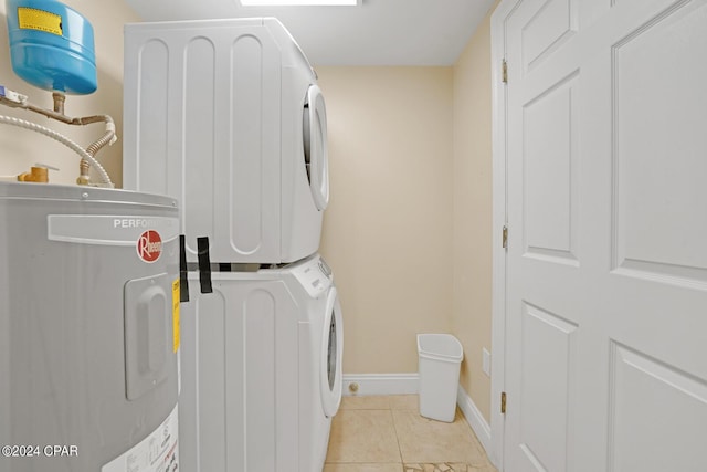 8715 Surf Dr Unit 304B, Panama City, FL 32408 - washroom with water heater, stacked washer / dryer, and light tile patterned floors