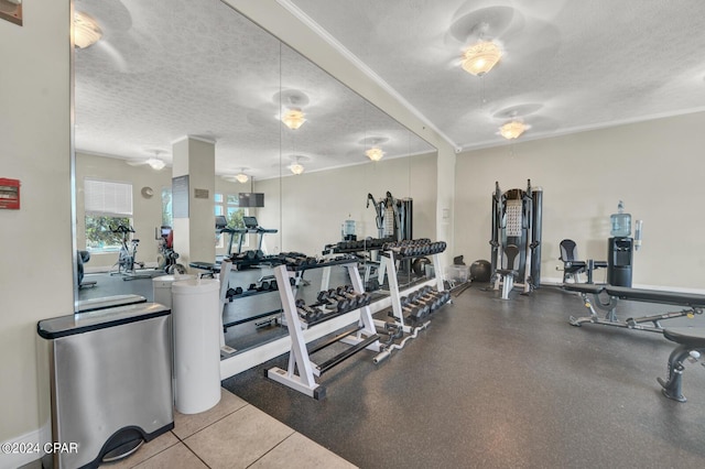 8715 Surf Dr Unit 304B, Panama City, FL 32408 - exercise room with a textured ceiling and crown molding