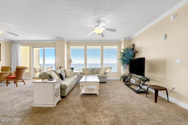 8715 Surf Dr Unit 304B, Panama City, FL 32408 - carpeted living area featuring a ceiling fan, plenty of natural light, a textured ceiling, and crown molding