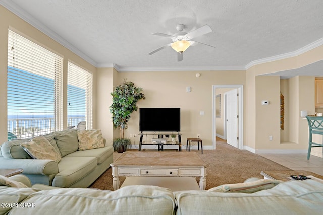 8715 Surf Dr Unit 304B, Panama City, FL 32408 - living area featuring crown molding, a ceiling fan, a textured ceiling, and light colored carpet