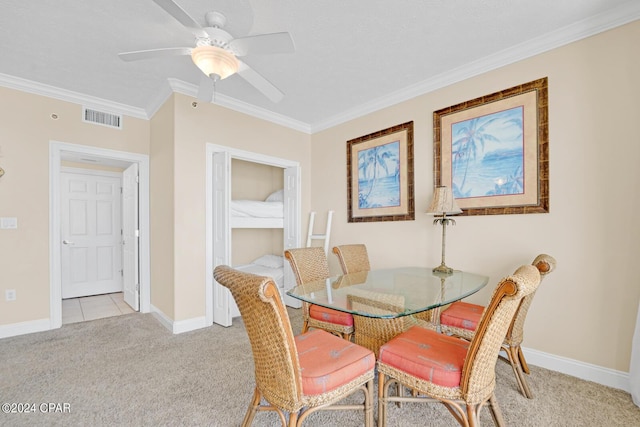 8715 Surf Dr Unit 304B, Panama City, FL 32408 - dining room featuring light colored carpet, ornamental molding, and a ceiling fan