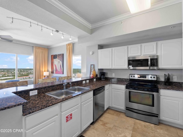 16819 Front Beach Rd Unit 2800, Panama City Beach, FL 32413 - kitchen with appliances with stainless steel finishes, track lighting, a sink, ornamental molding, and white cabinetry
