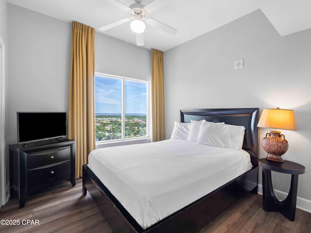 16819 Front Beach Rd Unit 2800, Panama City Beach, FL 32413 - bedroom with dark wood-style flooring, a ceiling fan, and baseboards