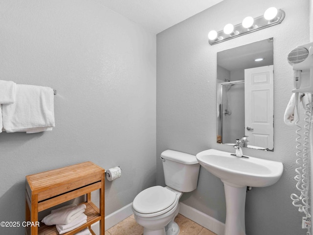 16819 Front Beach Rd Unit 2800, Panama City Beach, FL 32413 - full bathroom with toilet, tile patterned flooring, and a shower with shower door