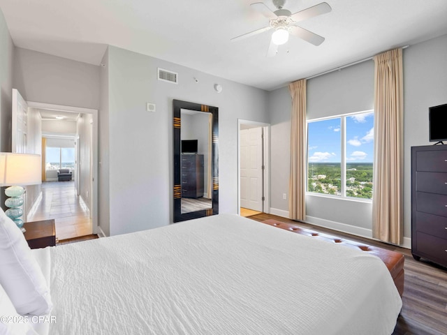 16819 Front Beach Rd Unit 2800, Panama City Beach, FL 32413 - bedroom with multiple windows, wood finished floors, baseboards, and ceiling fan
