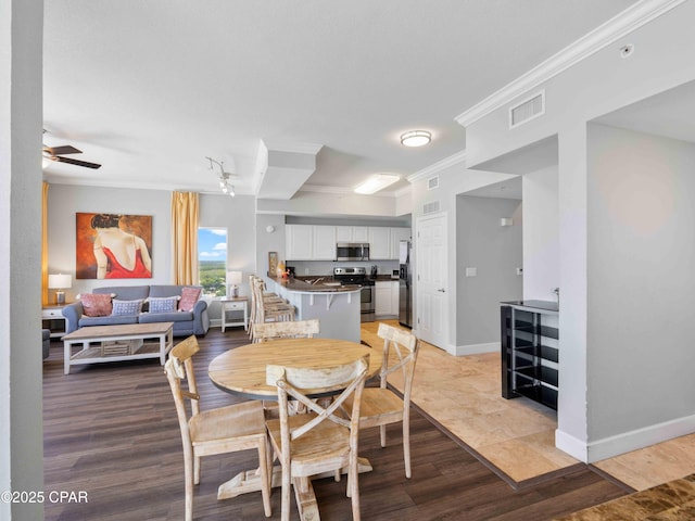 16819 Front Beach Rd Unit 2800, Panama City Beach, FL 32413 - dining room with crown molding, ceiling fan, light wood-style flooring, and baseboards