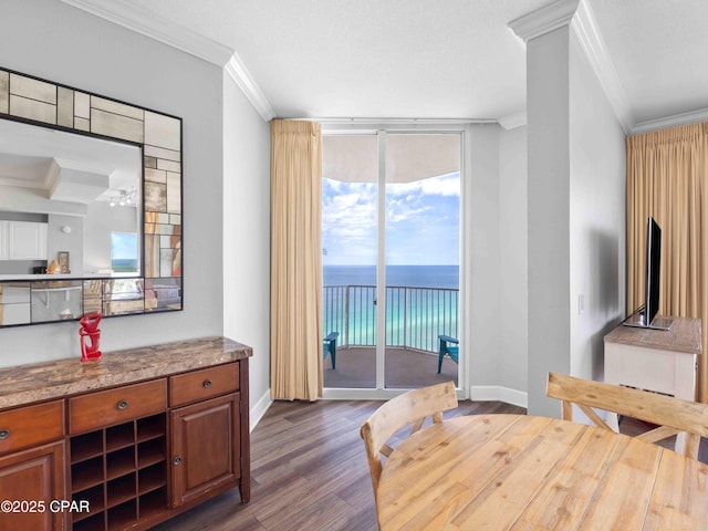 16819 Front Beach Rd Unit 2800, Panama City Beach, FL 32413 - dining room featuring crown molding, dark wood-style floors, baseboards, and a wall of windows
