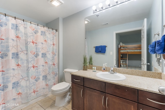 9902 Thomas Dr Unit 1735, Panama City Beach, FL 32407 - bathroom featuring vanity, tile patterned floors, toilet, and a shower with curtain