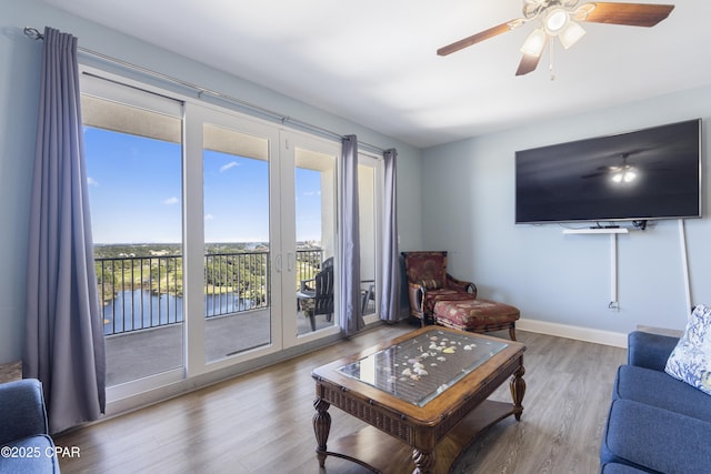9902 Thomas Dr Unit 1735, Panama City Beach, FL 32407 - living room with wood finished floors, baseboards, and a ceiling fan
