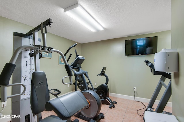 10519 Front Beach Rd Unit 601A, Panama City Beach, FL 32407 - workout room featuring a textured ceiling, tile patterned floors, and baseboards