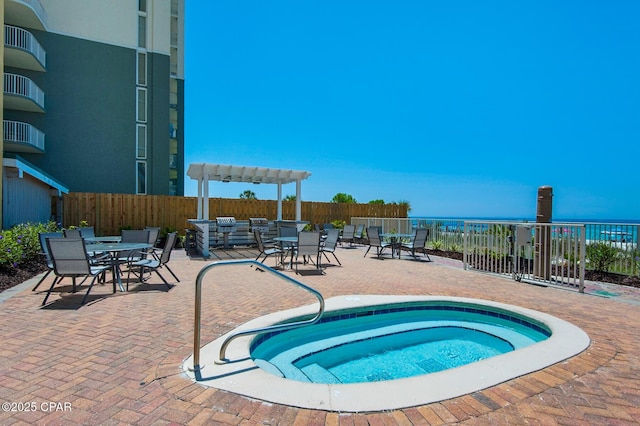 10519 Front Beach Rd Unit 601A, Panama City Beach, FL 32407 - view of swimming pool featuring outdoor dining space, a community hot tub, a patio, and a water view