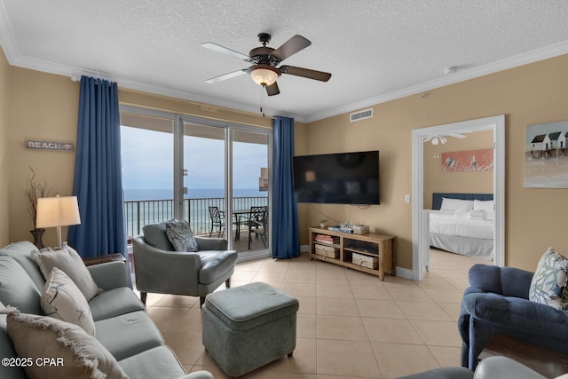 10519 Front Beach Rd Unit 601A, Panama City Beach, FL 32407 - living room featuring ceiling fan, light tile patterned floors, a textured ceiling, crown molding, and baseboards