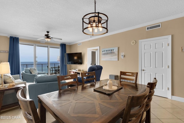 10519 Front Beach Rd Unit 601A, Panama City Beach, FL 32407 - dining area with a textured ceiling, ceiling fan, a chandelier, crown molding, and light tile patterned flooring