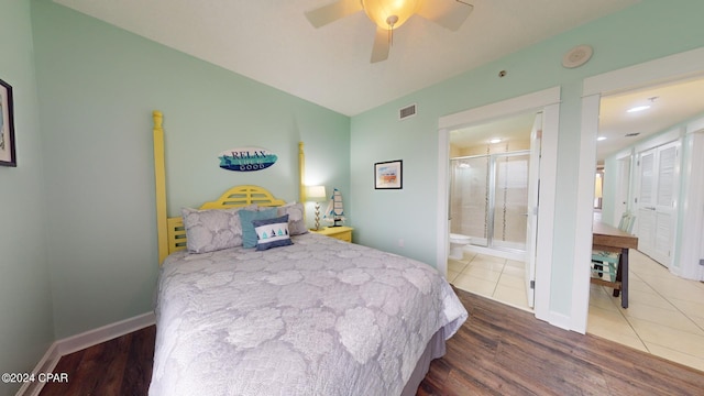 11800 Front Beach Rd Unit 2-201, Panama City Beach, FL 32407 - bedroom with wood finished floors, ensuite bath, baseboards, and a ceiling fan