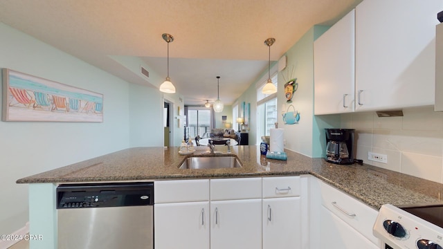 11800 Front Beach Rd Unit 2-201, Panama City Beach, FL 32407 - kitchen featuring dishwasher, a peninsula, a sink, decorative backsplash, and dark stone countertops