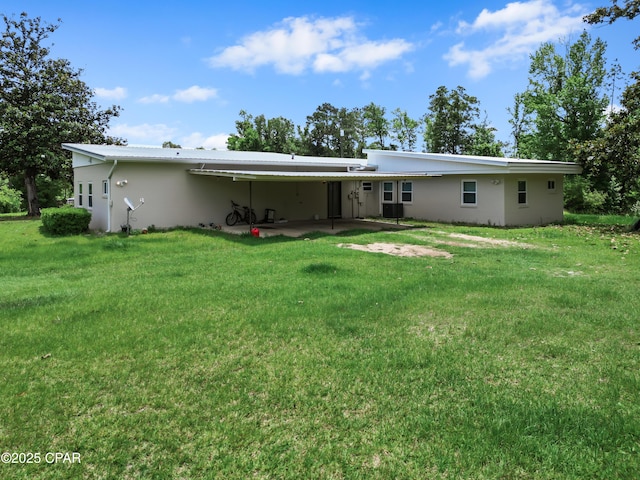 133 Devane Rd, Chattahoochee, FL 32324 - rear view of property featuring a carport, a lawn, stucco siding, and a patio