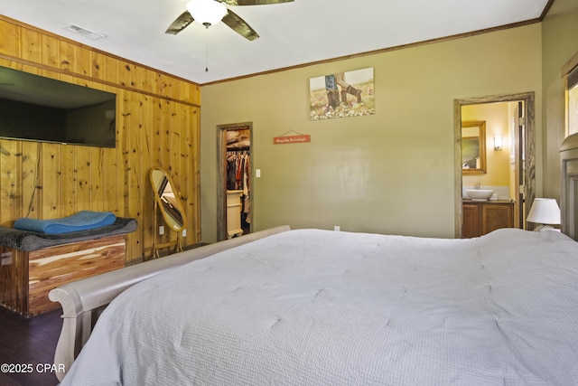 133 Devane Rd, Chattahoochee, FL 32324 - bedroom with ornamental molding, wood walls, a walk in closet, ensuite bathroom, and a closet