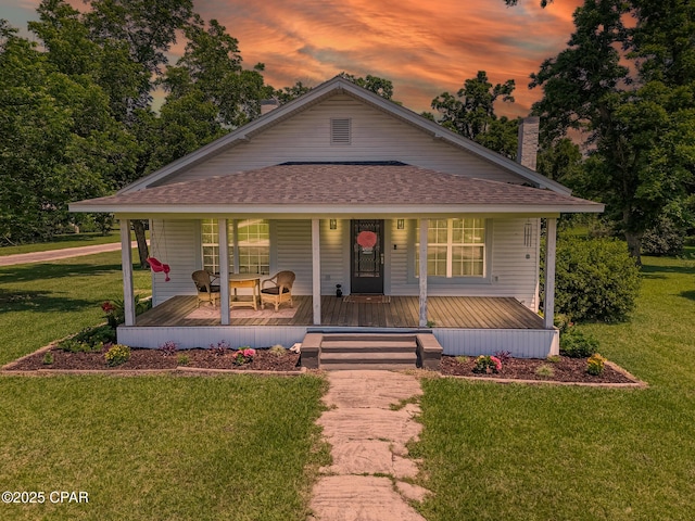 5138 8th Ave, Malone, FL 32445 - view of front of property with roof with shingles, a porch, a chimney, and a front yard