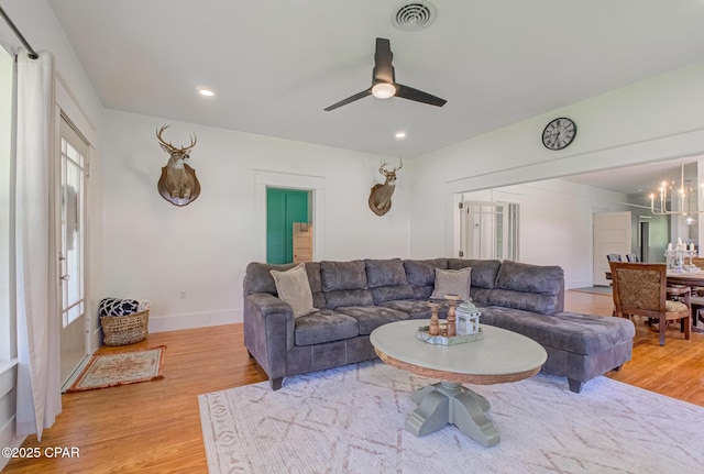 5138 8th Ave, Malone, FL 32445 - living room featuring light wood-style floors, ceiling fan, recessed lighting, baseboards, and a chandelier