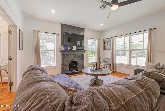 5138 8th Ave, Malone, FL 32445 - living area featuring wood finished floors, a ceiling fan, plenty of natural light, a fireplace, and recessed lighting