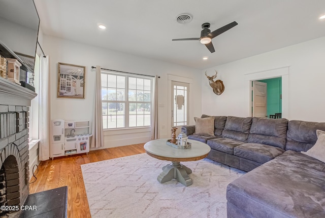 5138 8th Ave, Malone, FL 32445 - living room with a brick fireplace, ceiling fan, wood finished floors, and recessed lighting