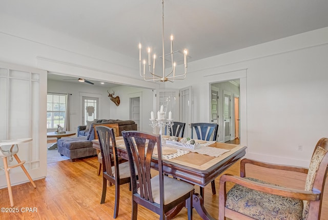 5138 8th Ave, Malone, FL 32445 - dining space featuring a chandelier, light wood-style flooring, a ceiling fan, and baseboards