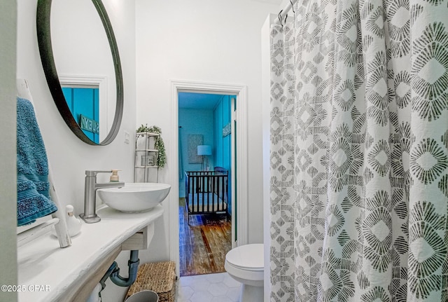 5138 8th Ave, Malone, FL 32445 - bathroom featuring a sink, toilet, tile patterned flooring, and a shower with curtain