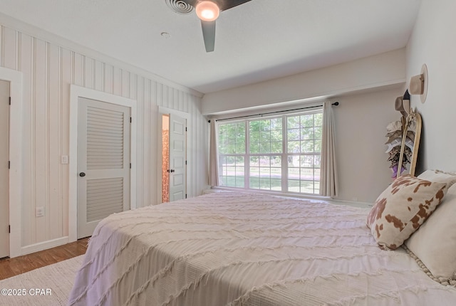5138 8th Ave, Malone, FL 32445 - bedroom featuring wood finished floors, ceiling fan, a closet, and baseboards
