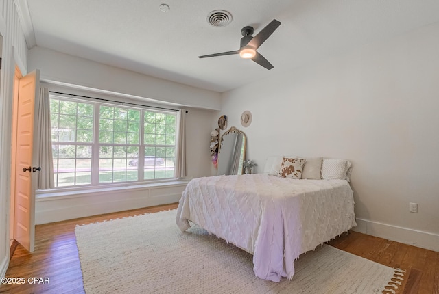 5138 8th Ave, Malone, FL 32445 - bedroom with wood finished floors, baseboards, and ceiling fan