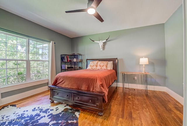 5138 8th Ave, Malone, FL 32445 - bedroom with baseboards, wood finished floors, and ceiling fan