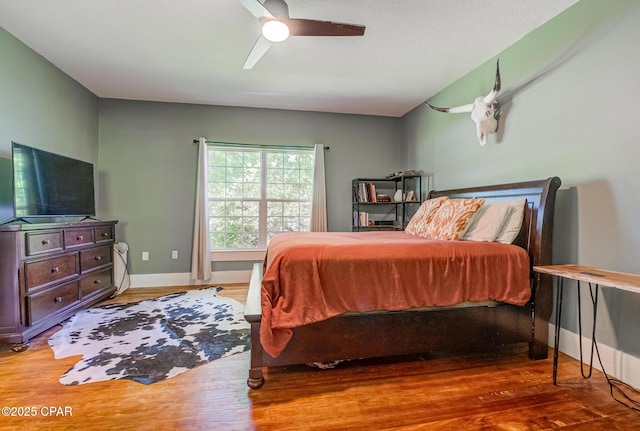 5138 8th Ave, Malone, FL 32445 - bedroom with wood finished floors, ceiling fan, and baseboards