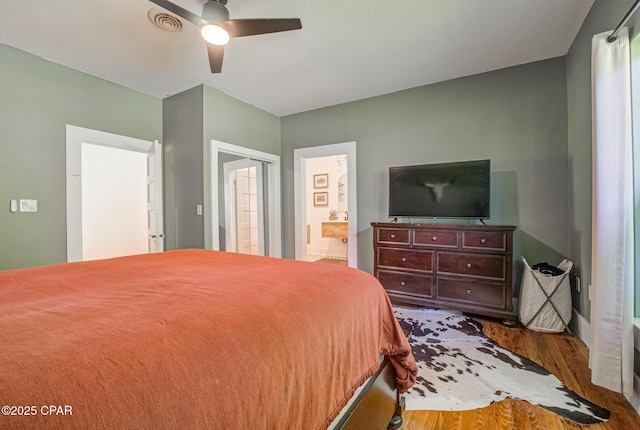 5138 8th Ave, Malone, FL 32445 - bedroom featuring wood finished floors, connected bathroom, and ceiling fan