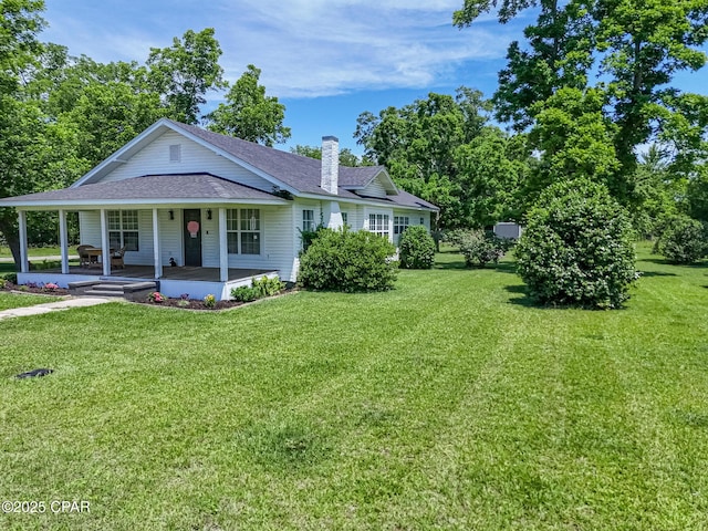 5138 8th Ave, Malone, FL 32445 - view of front of property featuring roof with shingles, covered porch, and a front lawn