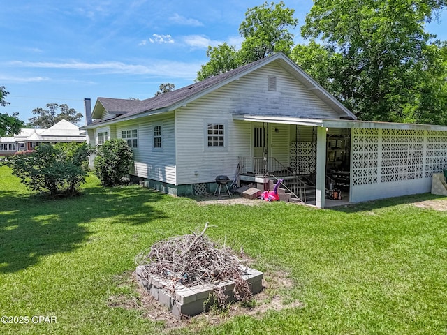 5138 8th Ave, Malone, FL 32445 - rear view of property with a lawn and a shingled roof