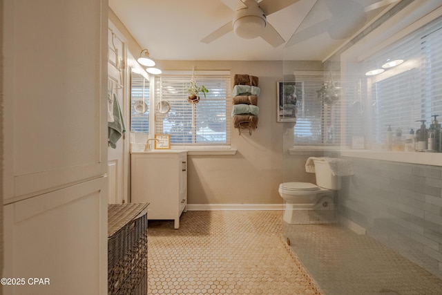 5821 S Lagoon Dr, Panama City, FL 32408 - bathroom featuring toilet, ceiling fan, walk in shower, tile patterned flooring, and baseboards