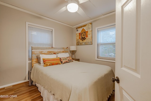 5821 S Lagoon Dr, Panama City, FL 32408 - bedroom with crown molding, light wood-style floors, baseboards, and ceiling fan